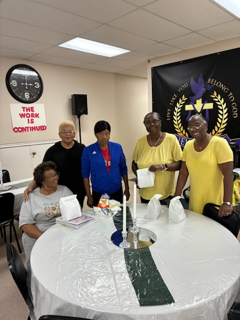 Ladies of New Light Baptist Church gathered around the fellowship table